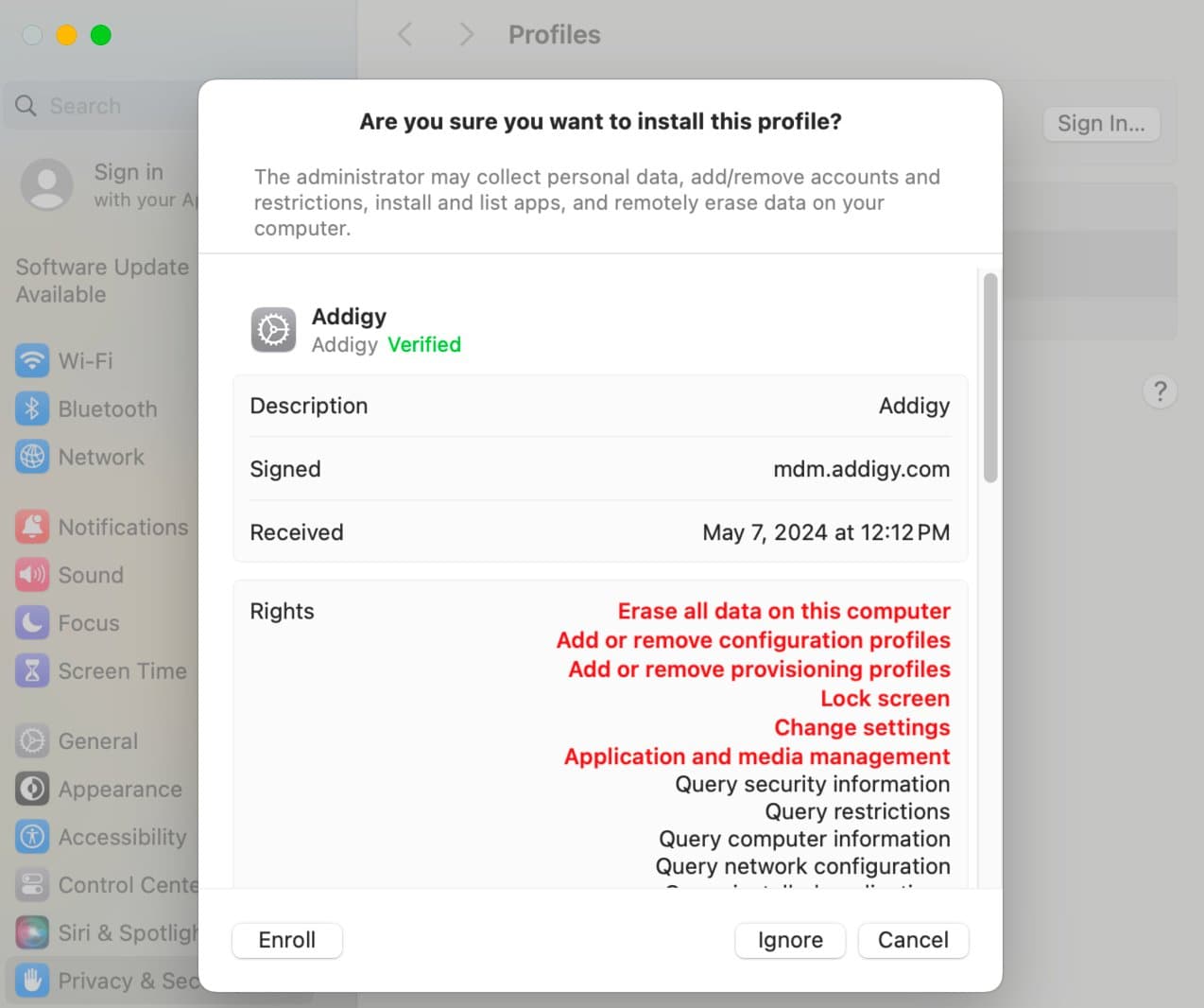 Confirmation dialog showing the Addigy management profile details with the Enroll button